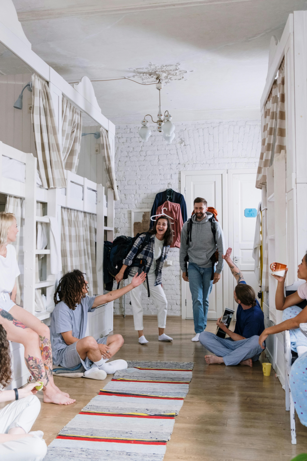 Travelers chatting in a hostel common area